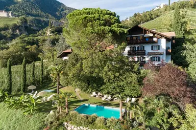 an aerial view of a villa with a swimming pool at Matailerhof in Tirolo