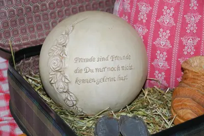an egg sitting in a basket with hay at Steierhof in Feldthurns