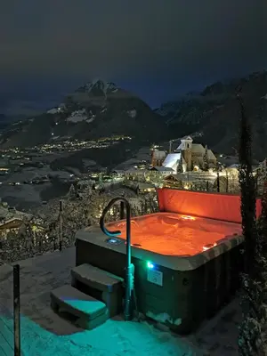 a jacuzzi tub with a view of a mountain at Active B&B Prairerhof in Schenna