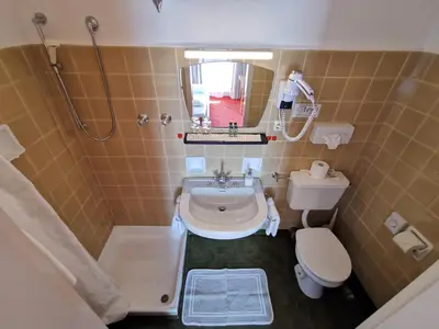 a small bathroom with a sink and a toilet at Active B&B Prairerhof in Schenna