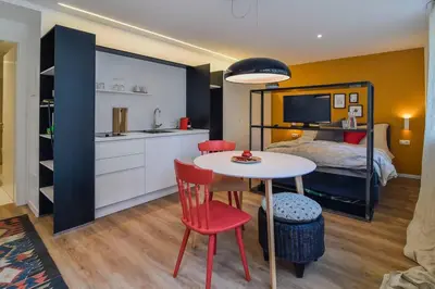 a kitchen and a bedroom with a table and a bed at Finesign 1 in Naturno