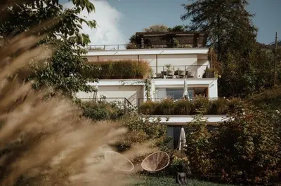 a white building with plants on the side of it at Villa Grüntaler by Hotel Schönblick in Rodengo