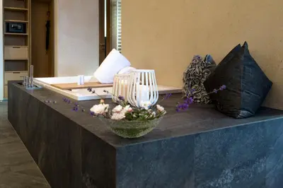 a lobby with a couch and flowers on a counter at Villa Grüntaler by Hotel Schönblick in Rodengo