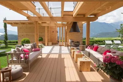 an outdoor patio with a wooden pergola and couches at Villa Grüntaler by Hotel Schönblick in Rodengo