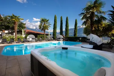 a large swimming pool with a resort style swimming pool at Residence Untermösslhof in Lana