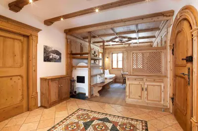 a room with a kitchen and a room with a stove at Residence Untermösslhof in Lana