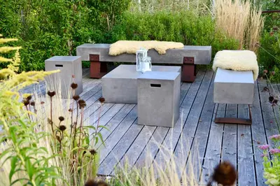 a patio with two benches and a table and chairs at Gapphof in Lagundo