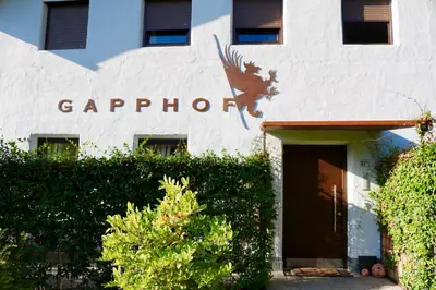 a white building with a sign on the side of it at Gapphof in Lagundo