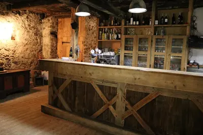 a bar with a wooden counter in a room at Gapphof in Lagundo