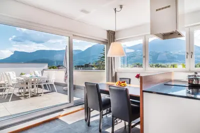 a kitchen and dining room with a view of the mountains at Hidalgo Suites in Postal