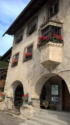 a building with flower boxes and windows on it at Vista Pelmo in Colle Santa Lucia