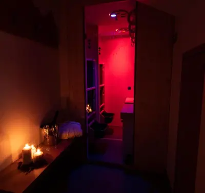 a dark room with candles and a red light at Chalet Stella Alpina in Val di Zoldo