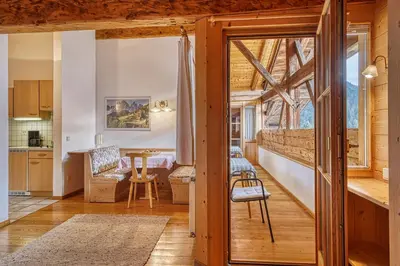 a kitchen and living room with a table and chairs at Zyprianhof in Nova Levante