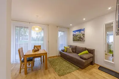 a living room with a couch and a table at Apartments Hubertus - central St Leonhard - free parking - Netflix - PasseiertalCard included - hiking and biking from doorstep in San Leonardo in Passiria