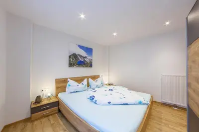a bedroom with a large bed in a room at Apartments Hubertus - central St Leonhard - free parking - Netflix - PasseiertalCard included - hiking and biking from doorstep in San Leonardo in Passiria