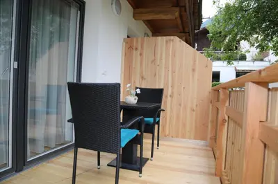 a small balcony with a black table and chairs at Apartments Hubertus - central St Leonhard - free parking - Netflix - PasseiertalCard included - hiking and biking from doorstep in San Leonardo in Passiria