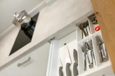 a kitchen cabinet with knives and utensils on it at Apartment Terme in Merano