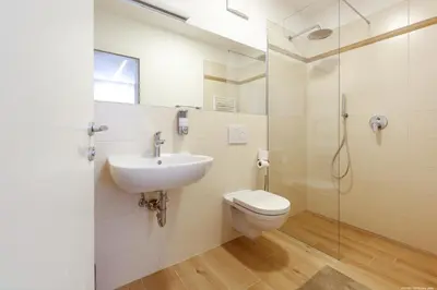 a bathroom with a toilet and a sink and a shower at Apartment Terme in Merano