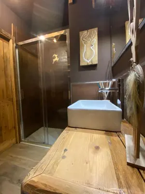 a bathroom with a tub and a glass shower at Calore di una Casa di Montagna in Campitello di Fassa
