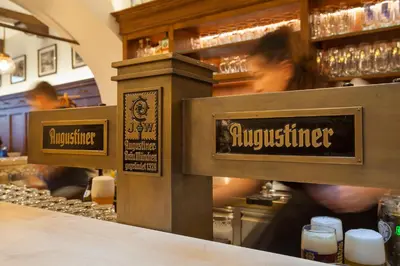 a bar with signs on the counter of a restaurant at Augustiner in Meran in Merano