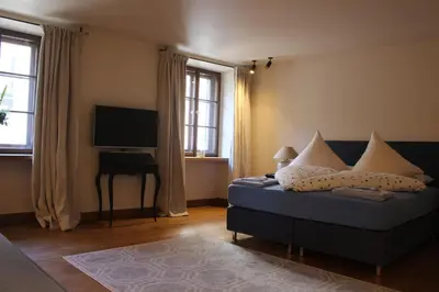 a living room with a couch and a flat screen tv at Augustiner in Meran in Merano
