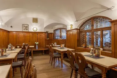 a dining room with wooden tables and chairs at Augustiner in Meran in Merano
