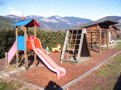a playground with a slide and a slideintend at Appartements Schusterbauer in Naz-Sciaves