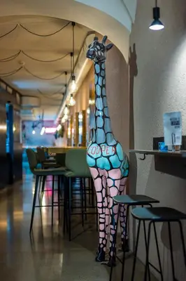 a statue of a giraffe on the wall of a restaurant at Stay COOPER l Cooper apartments in Bolzano