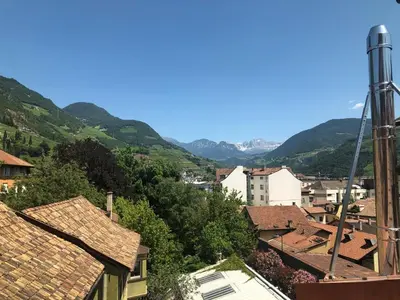 a view of a town with mountains in the background at Stay COOPER l Cooper apartments in Bolzano