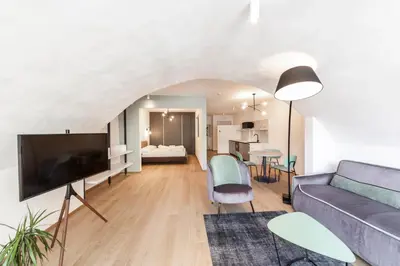 a living room with a couch and a tv at Stay COOPER l Cooper apartments in Bolzano