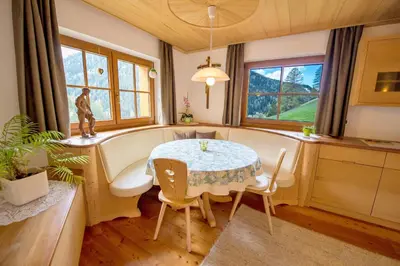 a kitchen with a table and a bath tub in a room at Chalet Prinoth in Selva di Val Gardena