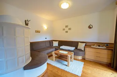 a living room with a couch and a table at Chalet Prinoth in Selva di Val Gardena