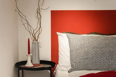 a bedroom with a bed with a vase on a table at Orizzonti d'Anaunia in Tassullo