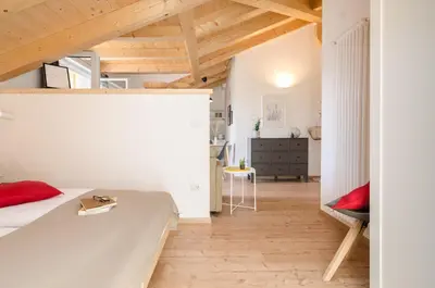 a bedroom with a bed and a desk in a room at Orizzonti d'Anaunia in Tassullo
