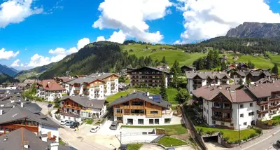 an aerial view of a town with houses and a mountain at Chalet Zenit in Selva di Val Gardena