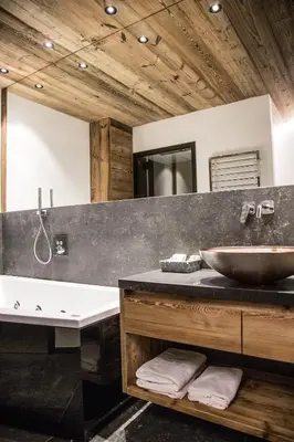 a bathroom with a sink and a large mirror at Chalet Zenit in Selva di Val Gardena