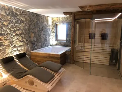 a bathroom with a bath tub and a tub at Chalet Zenit in Selva di Val Gardena