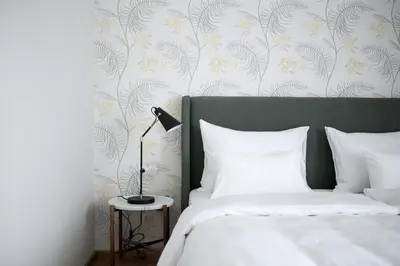 a bedroom with a bed and a lamp on a table at Villa Arnica, a Member of Design Hotels in Lana
