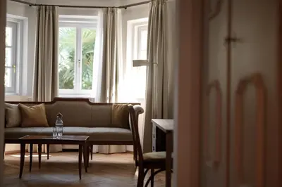 a living room with a couch and a table at Villa Arnica, a Member of Design Hotels in Lana