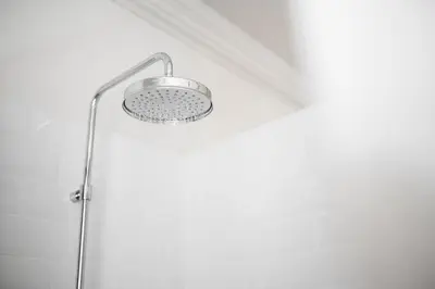 a shower with a shower head in a bathroom at Villa Arnica, a Member of Design Hotels in Lana