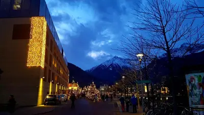 a city street with christmas lights and a mountain at Appartamento centro terme merano in Merano