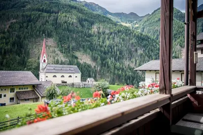 a view from a window of a village with flowers at Oberwirt in Selva dei Molini
