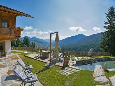 a group of buildings with mountains in the background at Chalet Piz da Peres in Valdaora