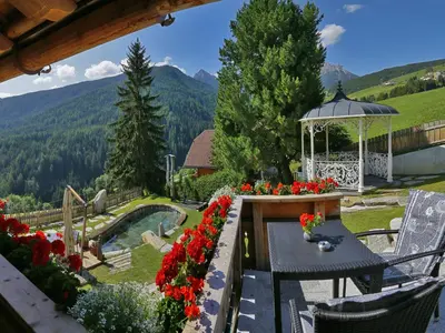 a large wooden house with two balconies on it at Chalet Piz da Peres in Valdaora