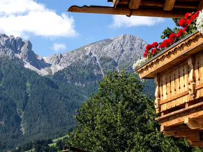 a house with a pond in the yard at Chalet Piz da Peres in Valdaora