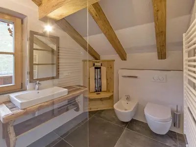 a dining room with a table and wooden walls at Chalet Piz da Peres in Valdaora