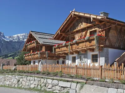 a wooden house with a fence in front of it at Chalet Piz da Peres in Valdaora