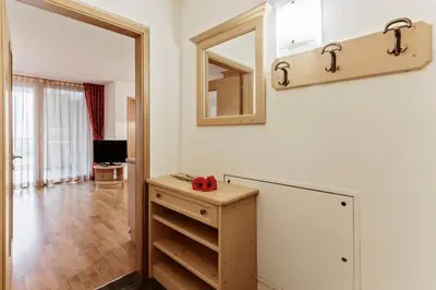 a bathroom with a wooden dresser and a mirror at Apartments Petlin in Ortisei