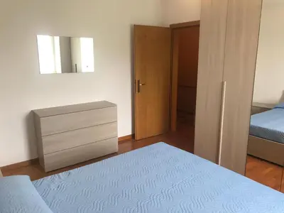 a bedroom with a bed and a dresser and a mirror at Appartamento Pezzol in Daiano