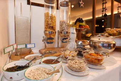 a buffet with many bowls of food on a table at Hotel Garni Vanadis in Ortisei